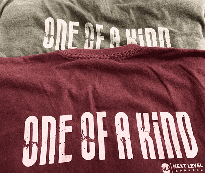 Custom printed gray and red shirts with ONE OF A KIND design and Next Level Apparel branding