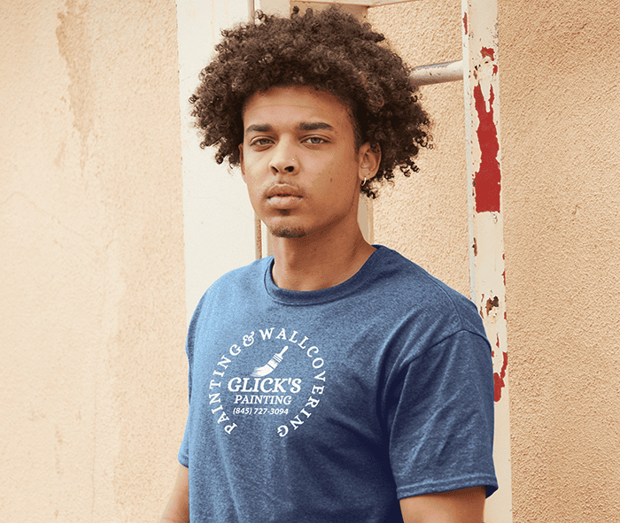 Young man wearing a blue custom T-shirt with Glick’s Painting logo
